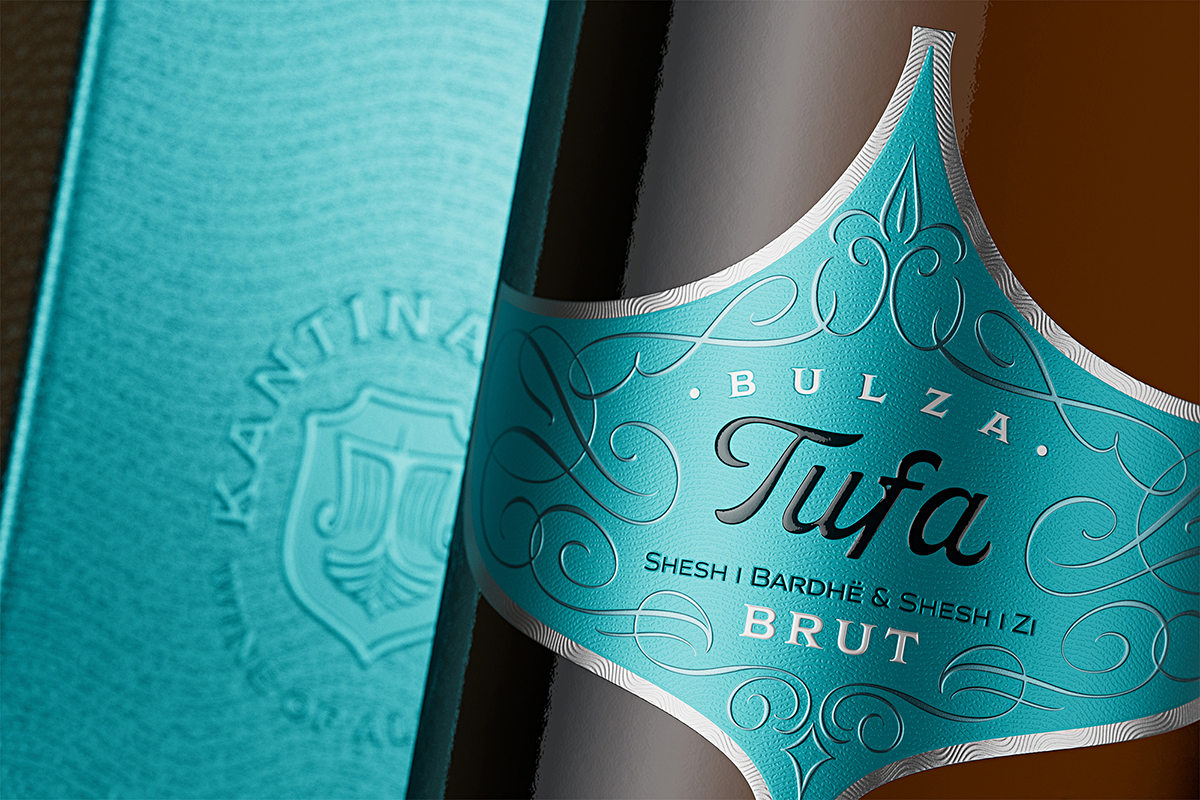 Custom die-cut sparkling wine label with silver foil border and wax-effect resin capsule badge, Tufa Bulza luxury wine branding