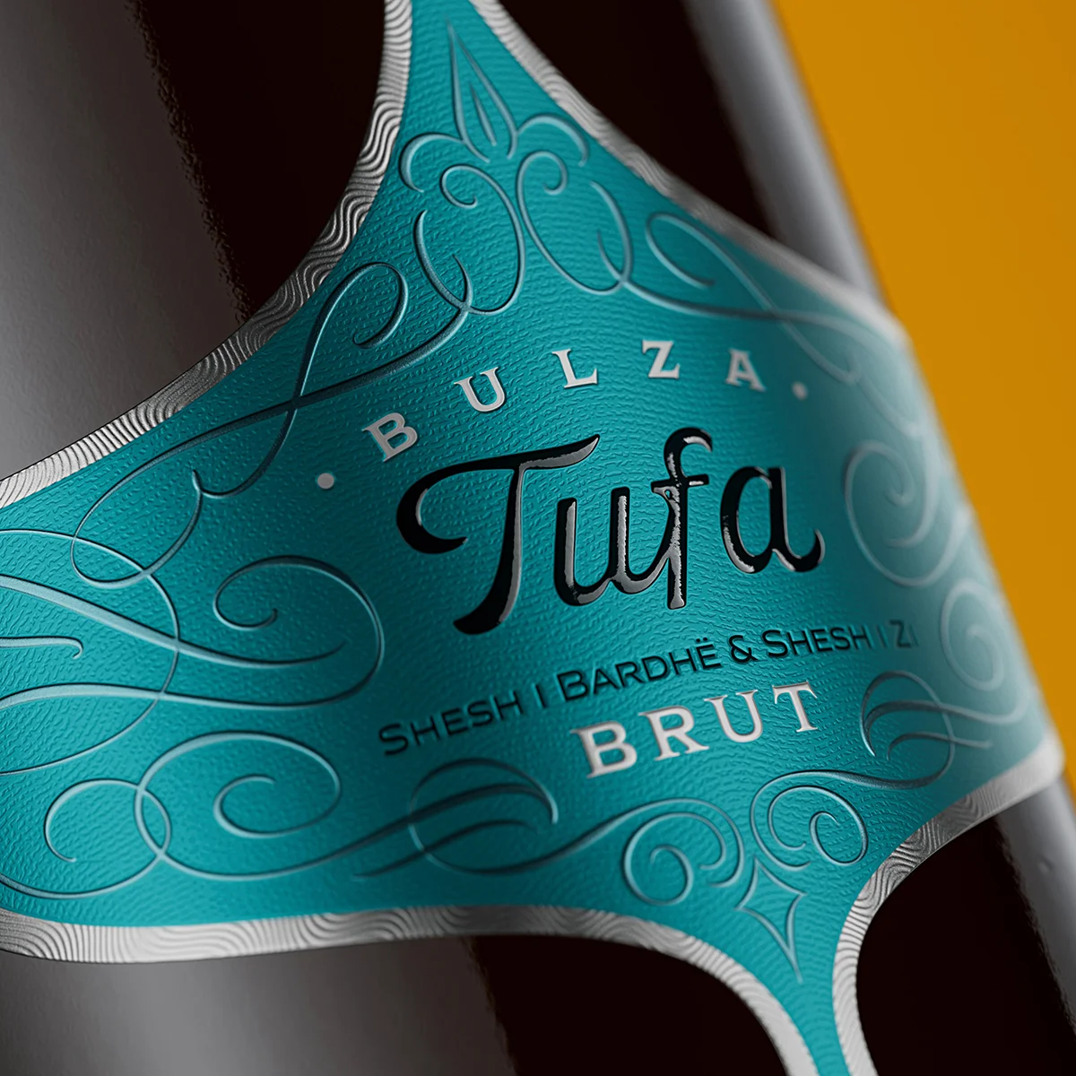 Hand-drawn calligraphic ornaments and deep-press embossed Tufa lettering on teal metallic luxury sparkling wine label, Bulza Brut