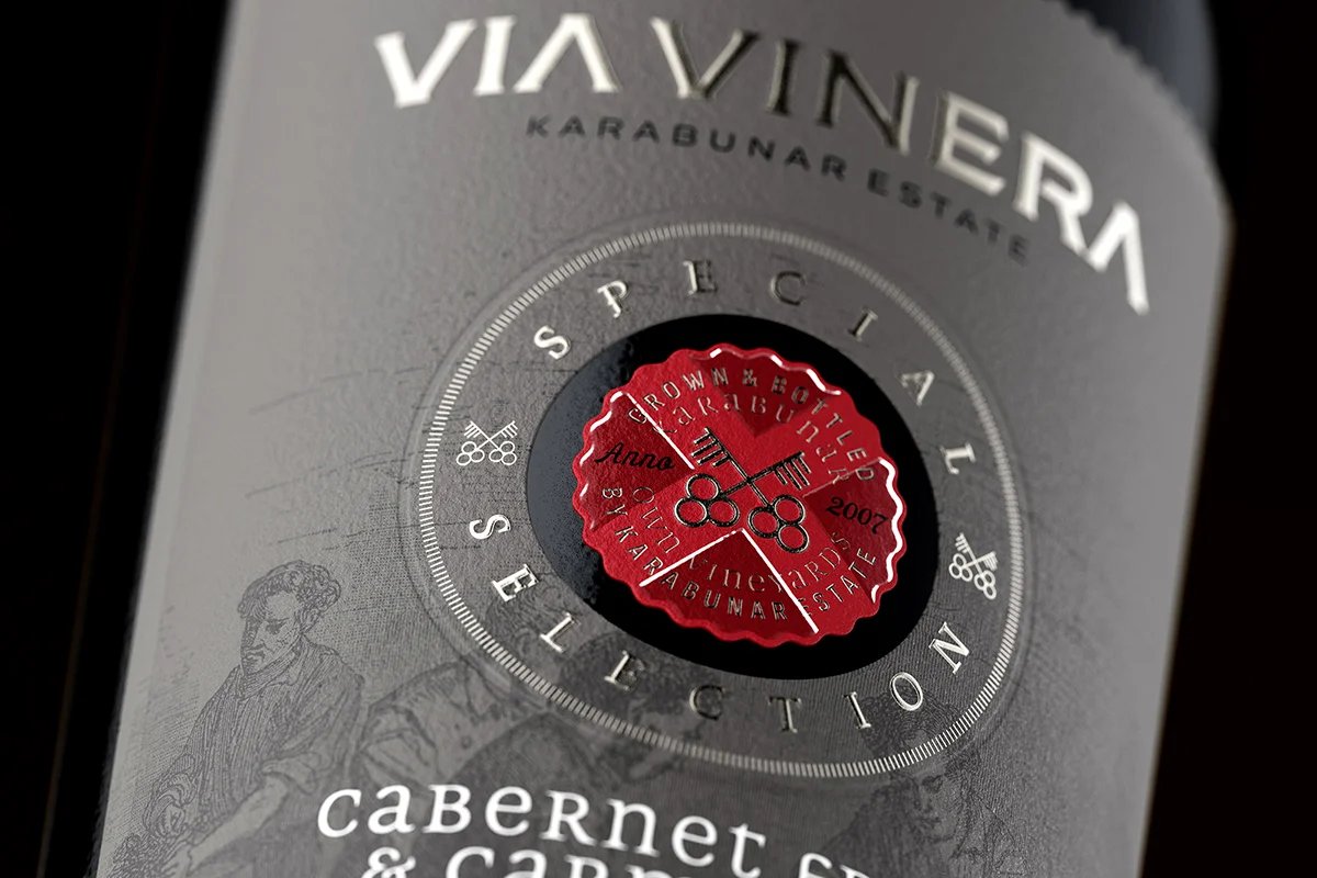 Via Vinera Special Selection medallion detail - see-through cut with Kurz foil, high-build raised varnish and embossed Special Selection typography on Cotton paper label