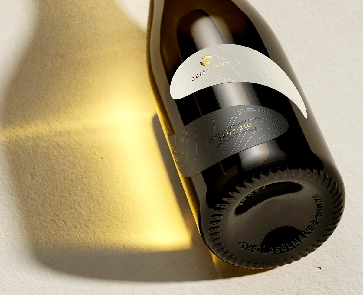 Staro Oryahovo Selection Crémant bottle base and gold muselet detail - distinctive wine label design viewed from below, warm golden light