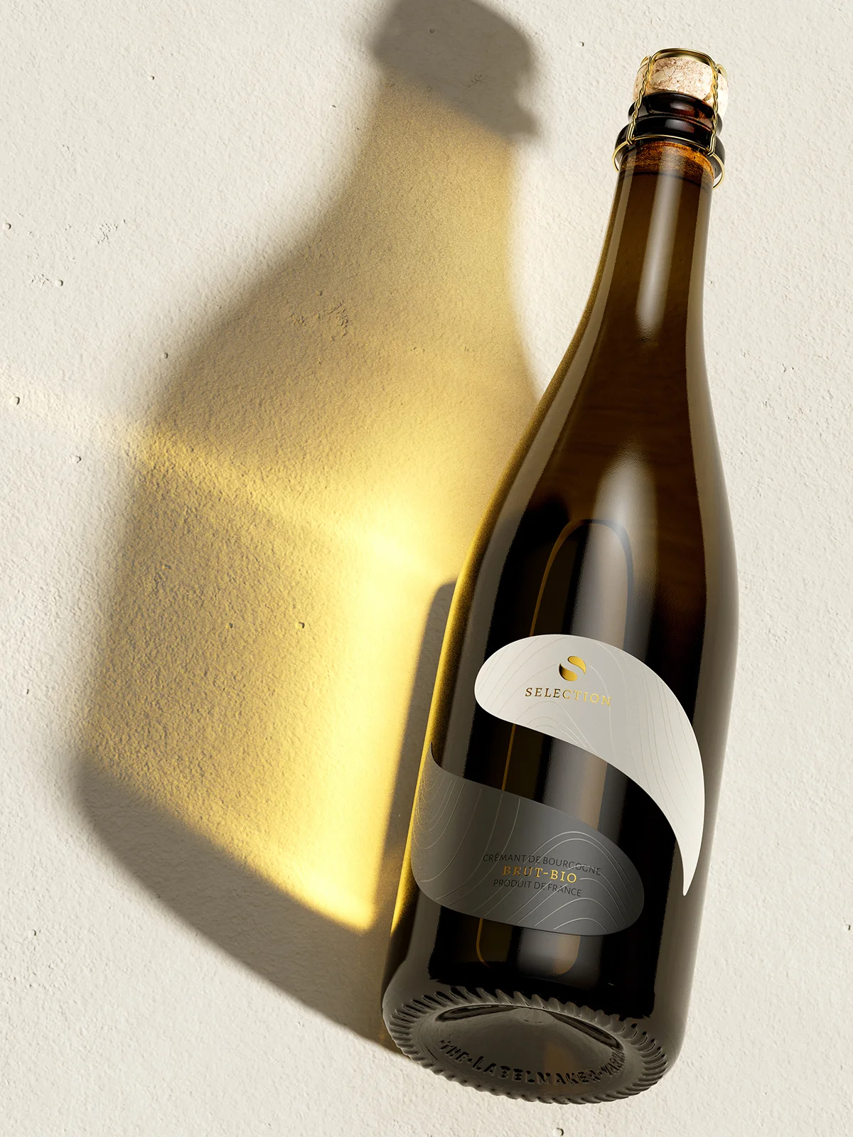 Staro Oryahovo Selection Crémant sparkling wine bottle - distinctive two-tone label with white upper half and dark silver lower half, gold foil Selection text, studio light