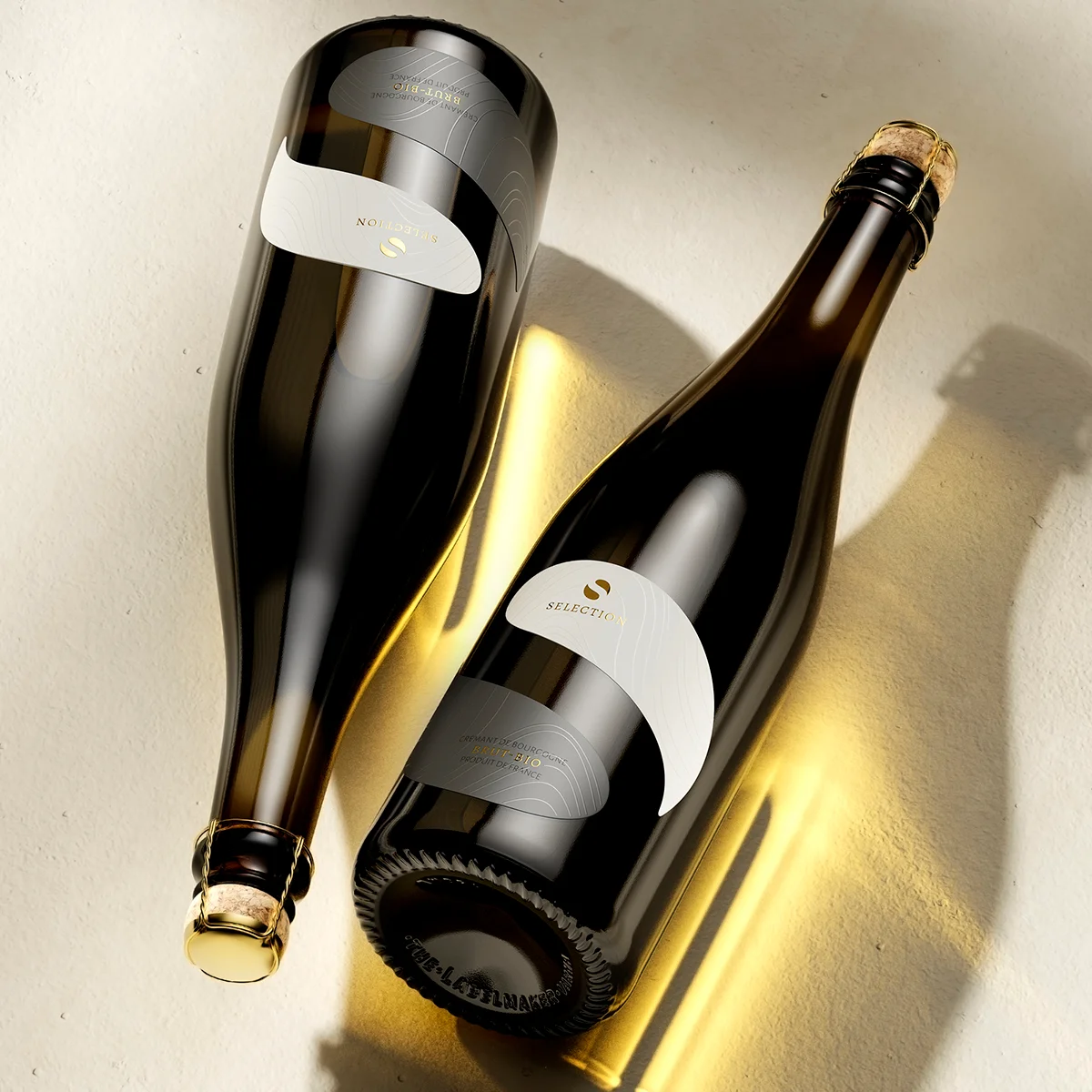 Staro Oryahovo Selection distinctive wine label design - two Crémant bottles on warm surface with dramatic light and shadow, two-tone label with gold foil